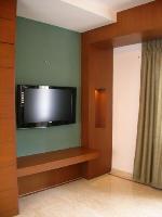 the flat screen television opposite the bed.